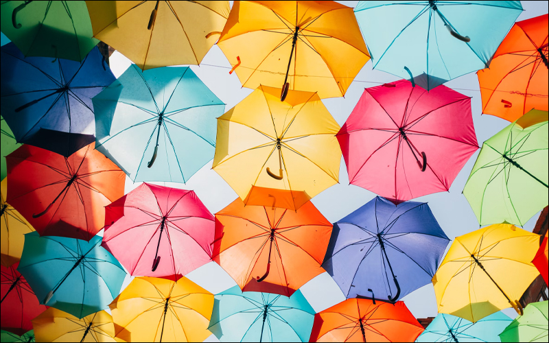 A bunch of colorful umbrellas viewed from below.