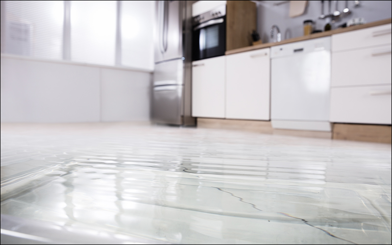 Kitchen with water covering floor.