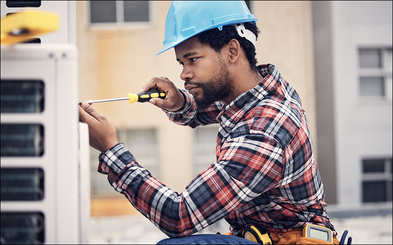 Repairman working on AC unit.