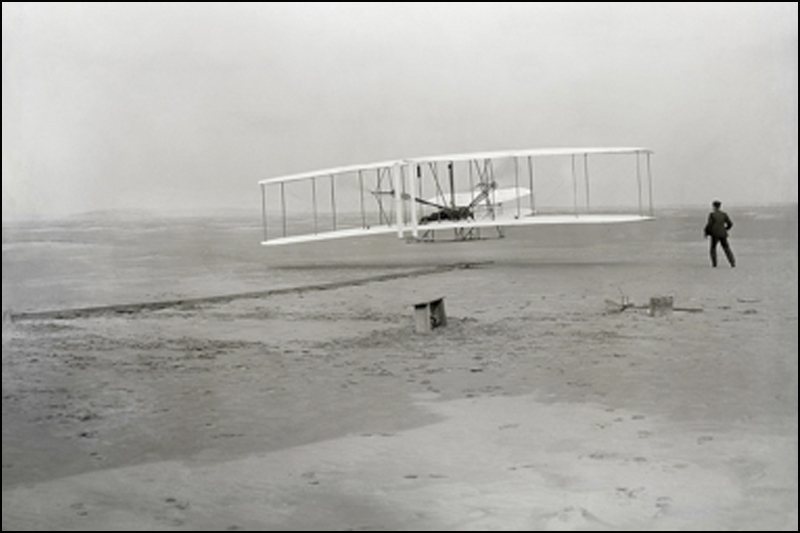 First flight of the Wright Flyer. Orville Wright was piloting; his brother Wilbur was running at win