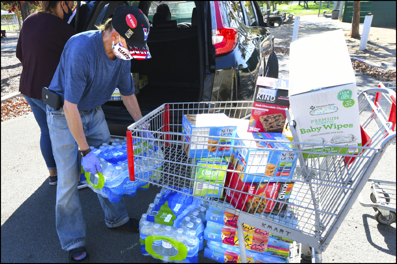 Grocery cart of supplies being unloaded