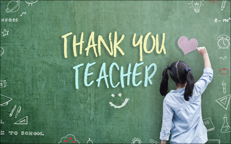 Girl drawing on green chalkboard that says 
