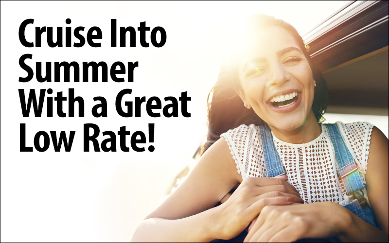 Cruise Into Summer With a Great Low Rate! Photo of woman smiling in car.