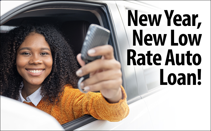 New Year, New Low Rate Auto Loan! Photo of woman smiling in car holding keys.