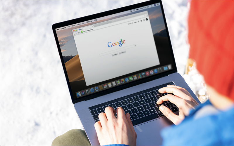 Person using laptop with Google screen on browser.