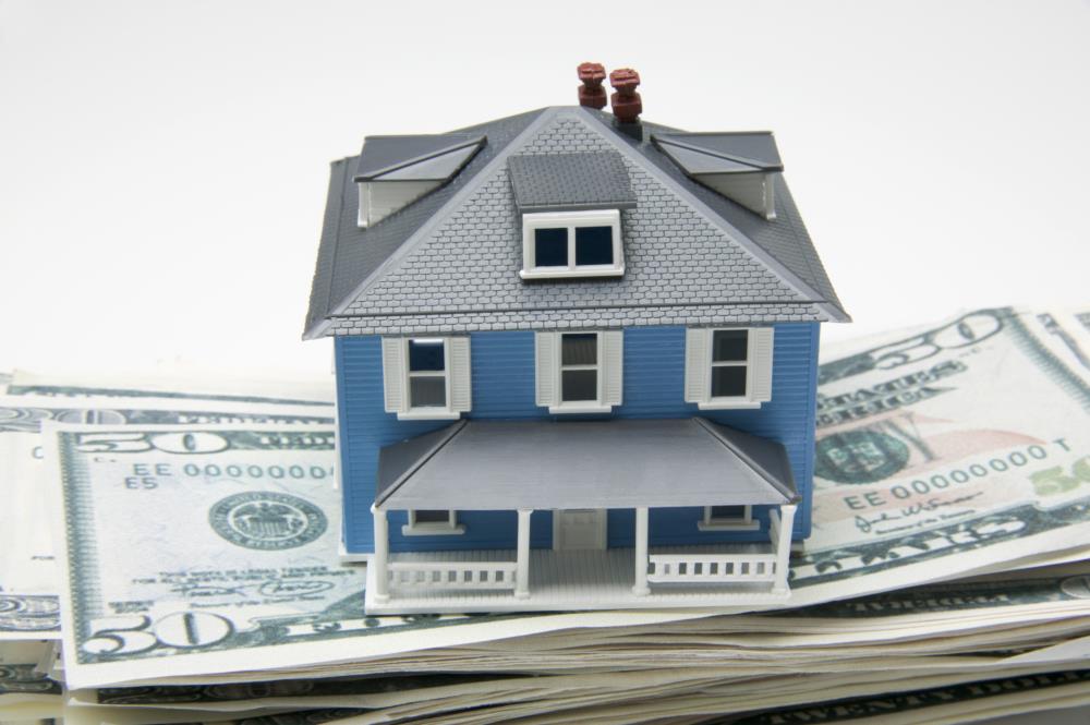 This is an image of a house on a stack of money