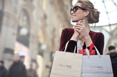 woman holding 2 shopping bags