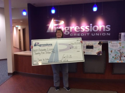 woman holding large check