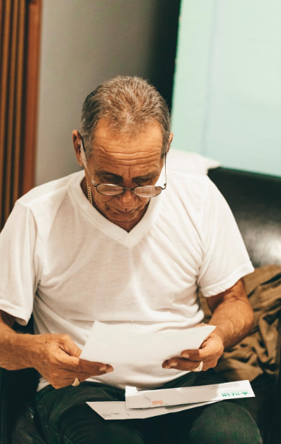 elderly man reading mail