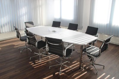 a white table surrounded by 8 black chairs